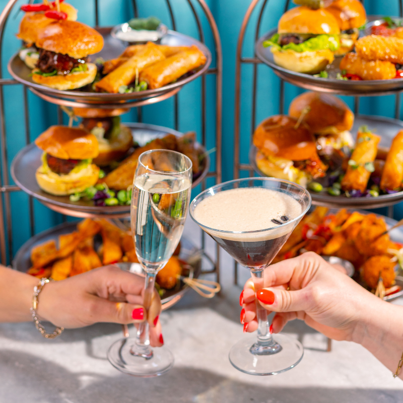Photo of a glass of bubbly, espresso martini and brunch food at Dirty Martini