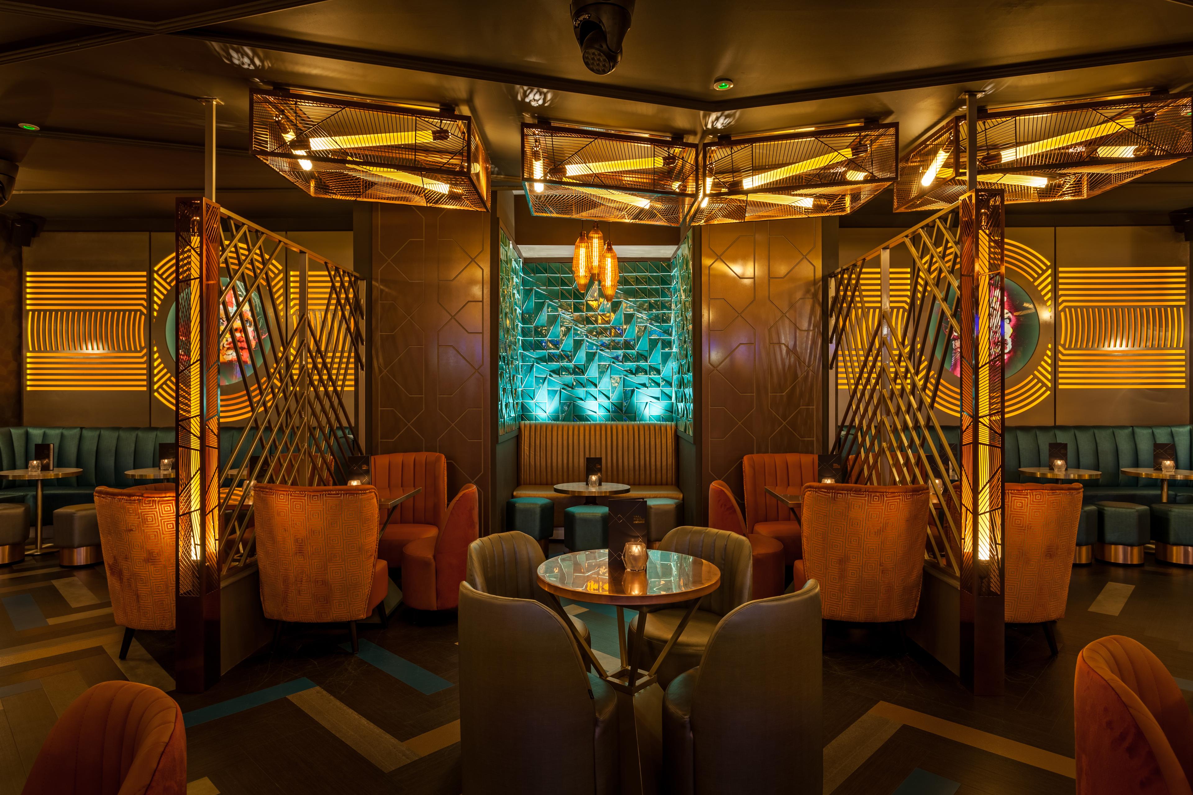 The interior of Dirty Martini in Manchester showing an area with booth seating and tables